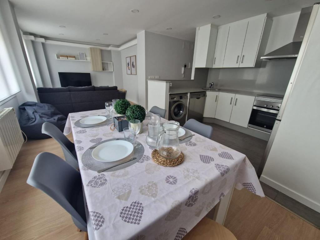 a dining room table with a table cloth on it at Apartamento Cancela, super luminoso y bien situado in A Coruña