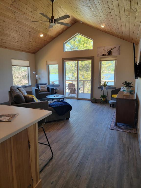 a living room with a couch and a table at Lakeshore Lodging Suites in Homer