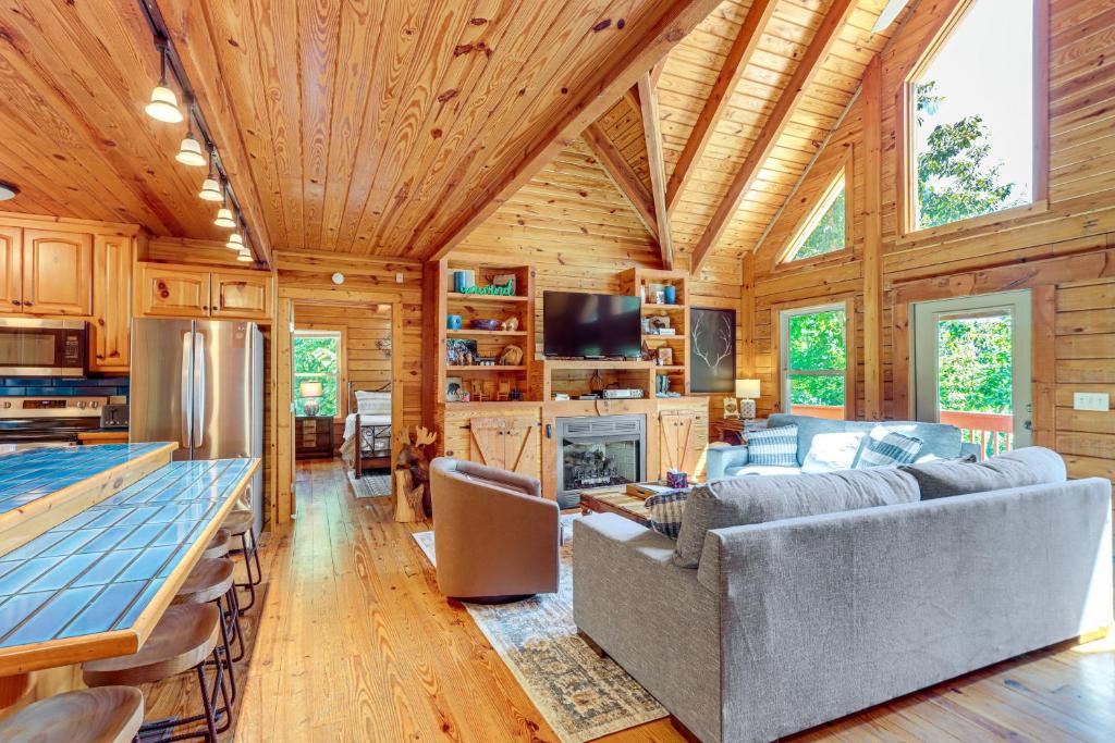 a living room with wooden walls and a wooden ceiling at Owls Nest Pet-Friendly Cabin with Private Hot Tub in Ranger