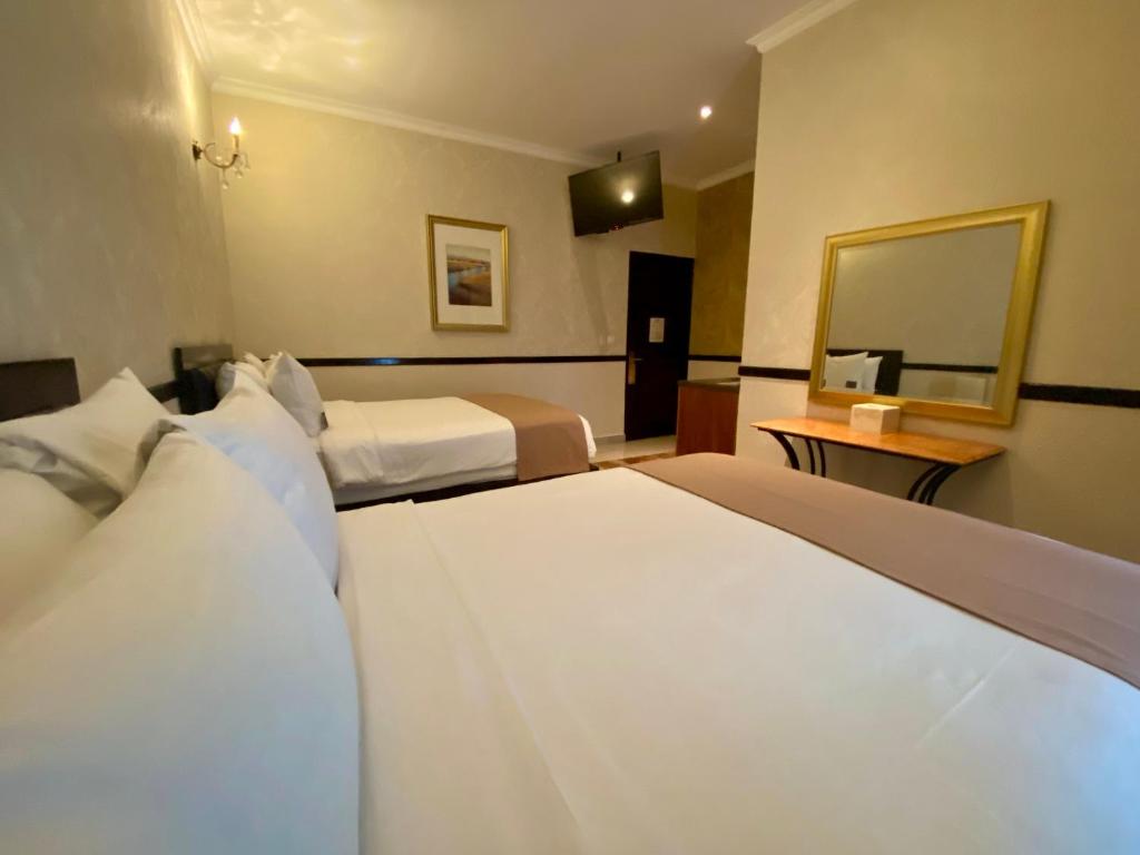 Postel nebo postele na pokoji v ubytování Hotel Palacio Maya