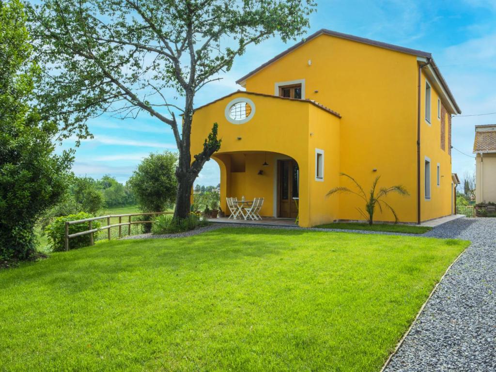 a yellow house with a tree in the yard at Holiday Home Il Venturino by Interhome in Fucecchio