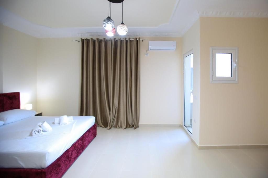 Postel nebo postele na pokoji v ubytování Oasis Residence