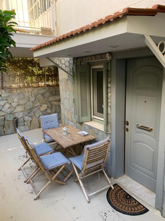 a table and chairs sitting on a patio at Dori's Seaside Apartment in Athens