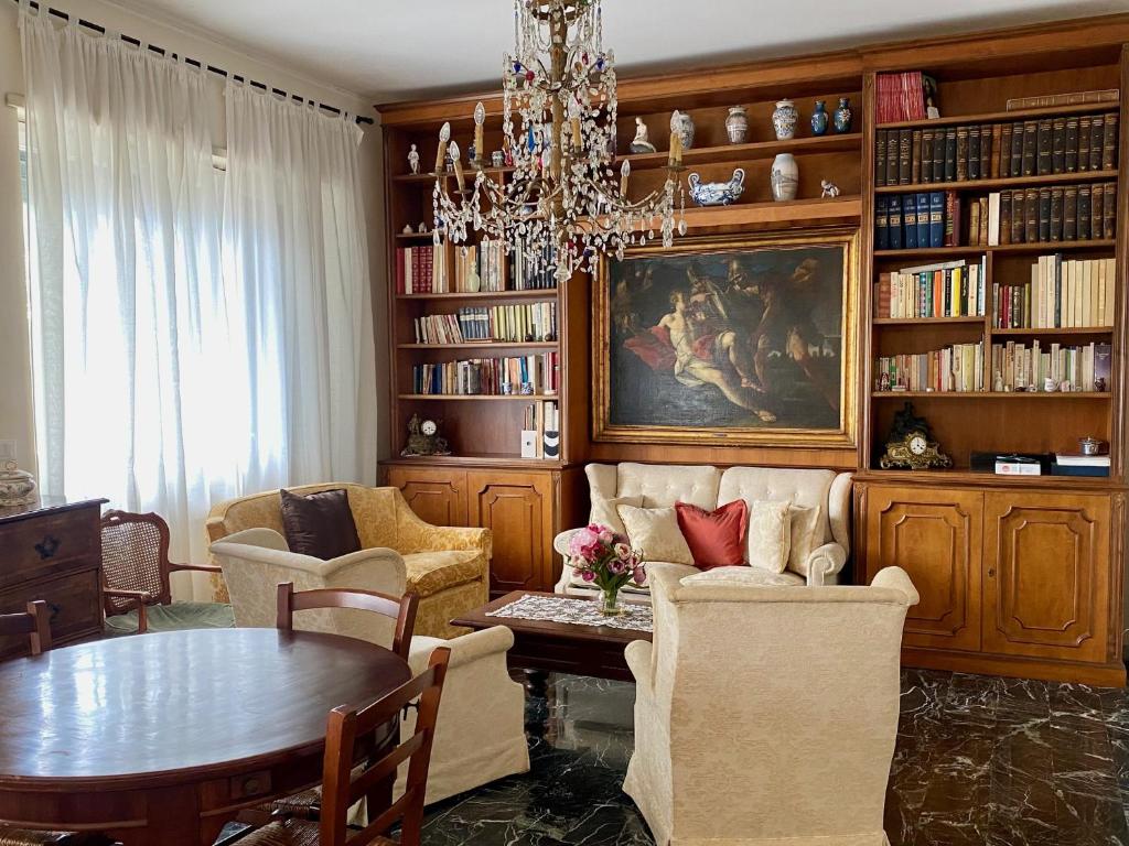 a living room with a table and a chandelier at Genoa view & hiking in italian riviera in Genoa