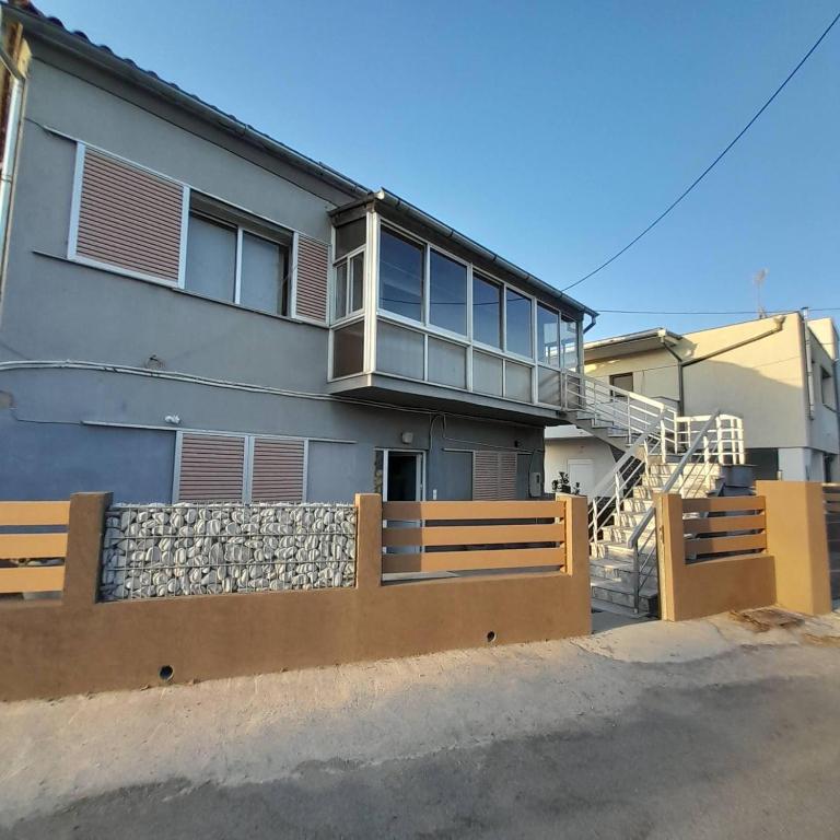 a house with a balcony on the side of it at Makri Vacation House in Alexandroupoli
