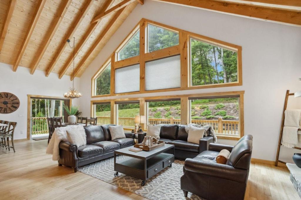 ブーンにあるHidden Haven Cabinのリビングルーム(革製家具、大きな窓付)