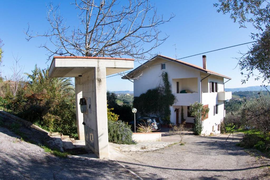 a house on a hill with a sign in front of it at Orion House in Pianella