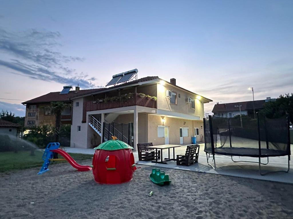 a house with a playground in front of it at Borche Apartments in Bogdanci