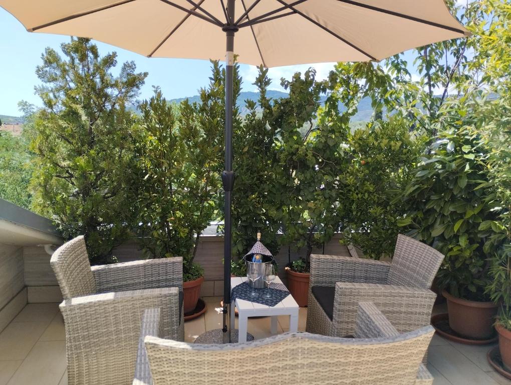 a table with an umbrella on a patio at Bellini's House in Montecatini Terme