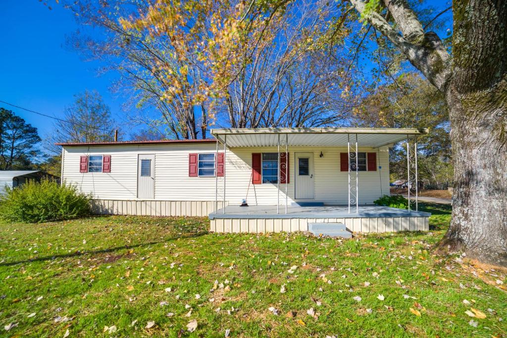 a small white house with a tree in a yard at Waterloo Home Walk to Pickwick Lake Fishing Pier! in Waterloo