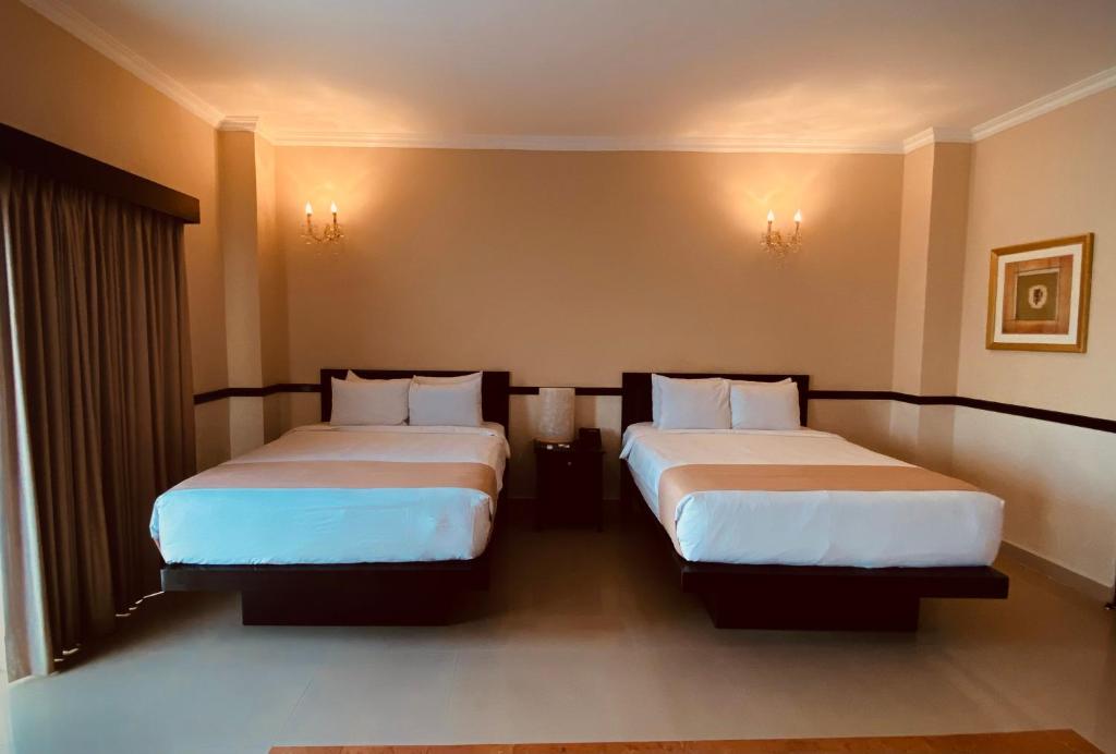 Postel nebo postele na pokoji v ubytování Hotel Palacio Maya