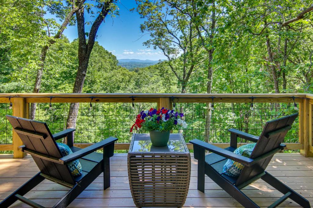 a deck with two chairs and a table with a vase of flowers at Modern Hendersonville Home Deck and Mountain Views! in Hendersonville
