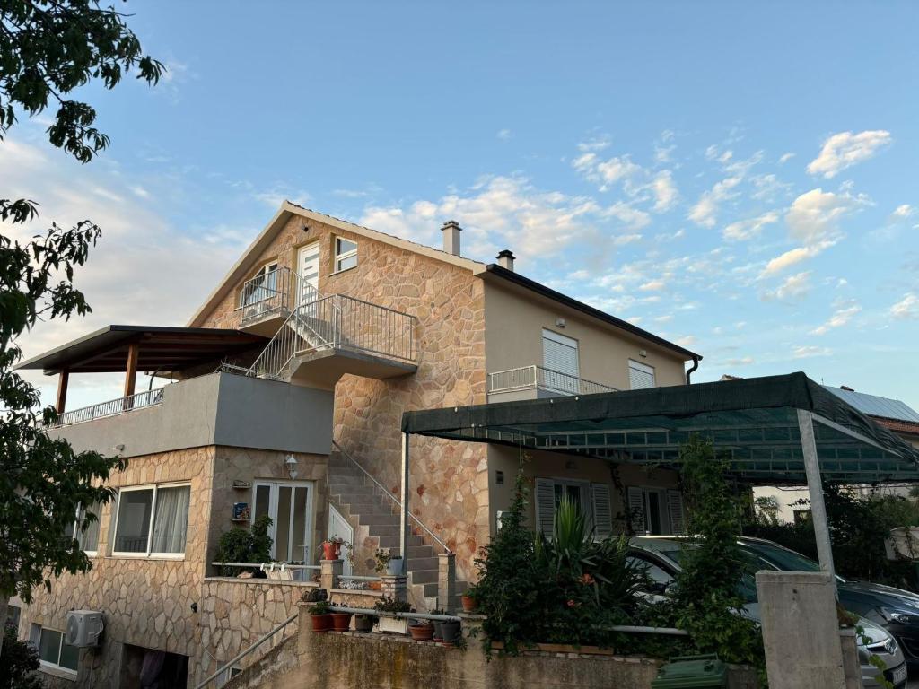 a house with a balcony on top of it at Apartments with parking space Jelsa, Hvar - 4040 in Jelsa