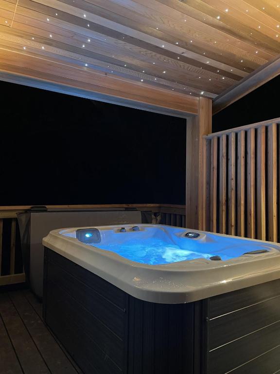a jacuzzi tub in a room with a wooden ceiling at Pettico Lodge in Eyemouth