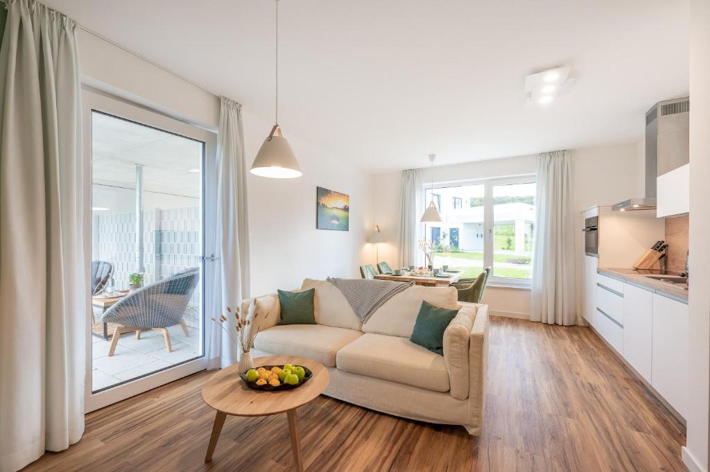 a living room with a couch and a table at Ferienwohnung Blickwinkel in Lohme