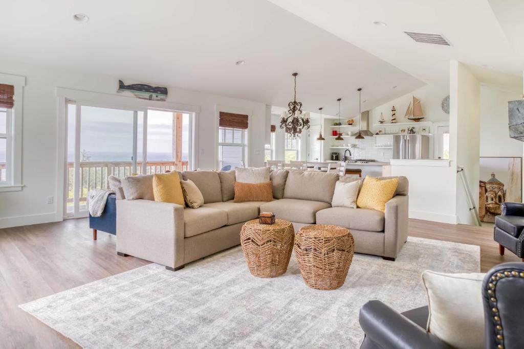 a living room with a couch and a kitchen at Searenity Now Depoe Hills in Depoe Bay