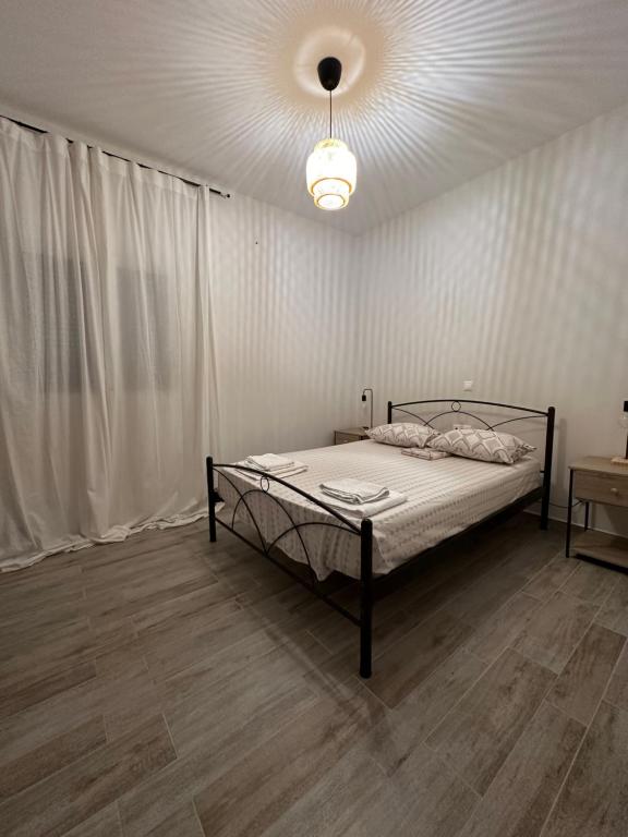 a bedroom with a bed and a ceiling at Melina house in Ayiá