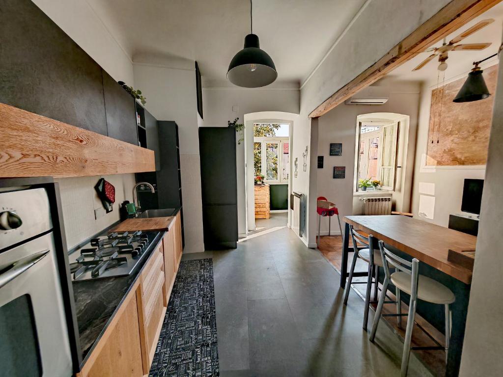 a kitchen with a table and a stove top oven at Saint Jack Luxury in Trieste