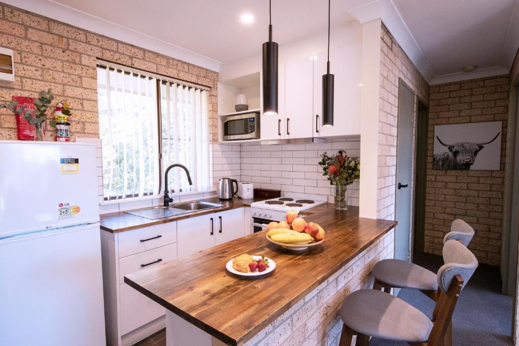 a kitchen with a counter with a bowl of fruit on it at 52 on Mort in Lithgow