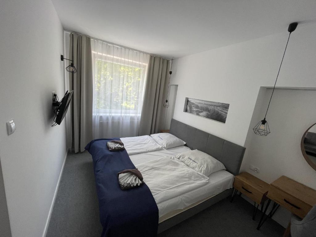Posteľ alebo postele v izbe v ubytovaní Sanatorium Muszelka