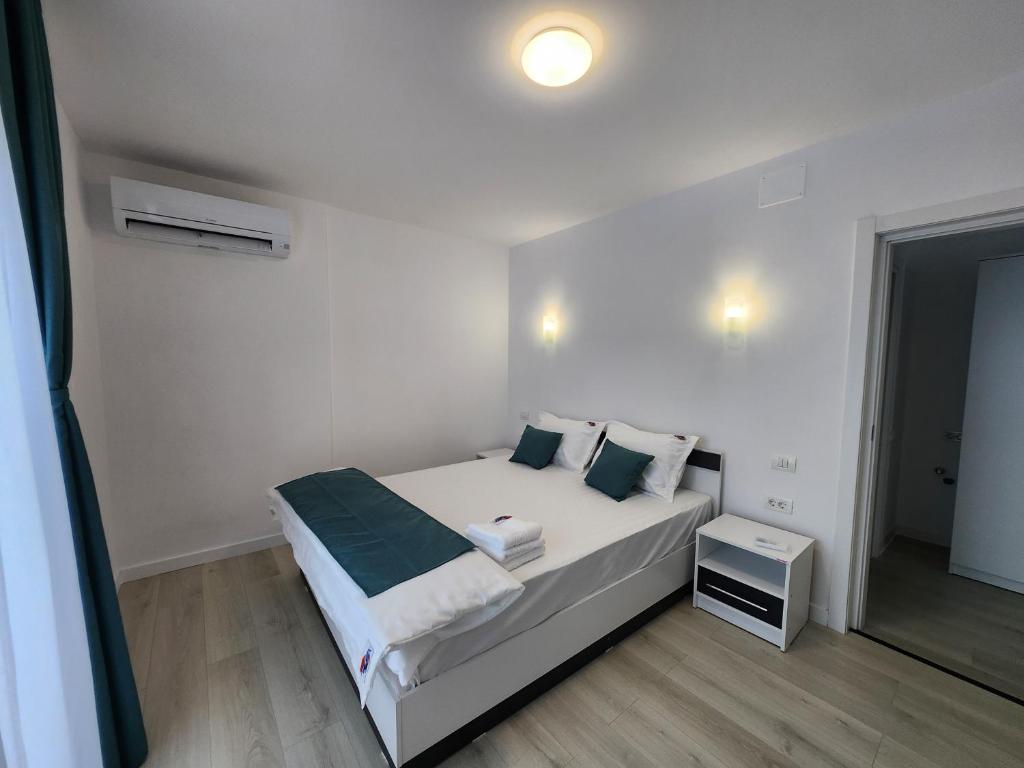 Ένα ή περισσότερα κρεβάτια σε δωμάτιο στο Complex Rezidential Vamaland