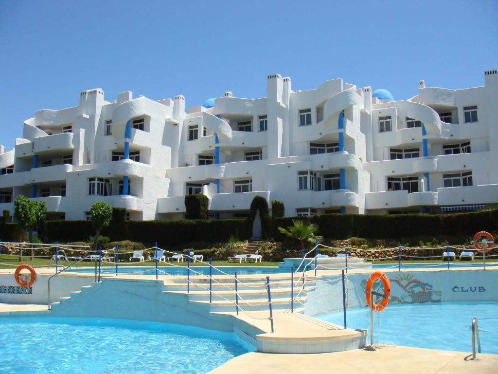 a large white apartment building with a swimming pool at Ona Campanario in La Cala de Mijas