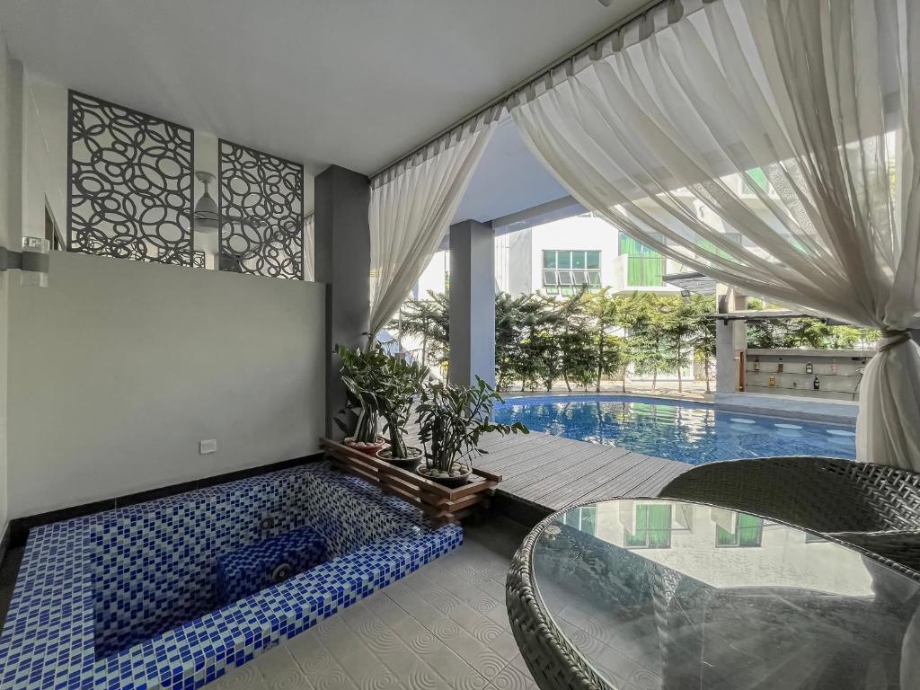 a living room with a swimming pool and a table and a pool at Eloisa Royal Suites in Mactan