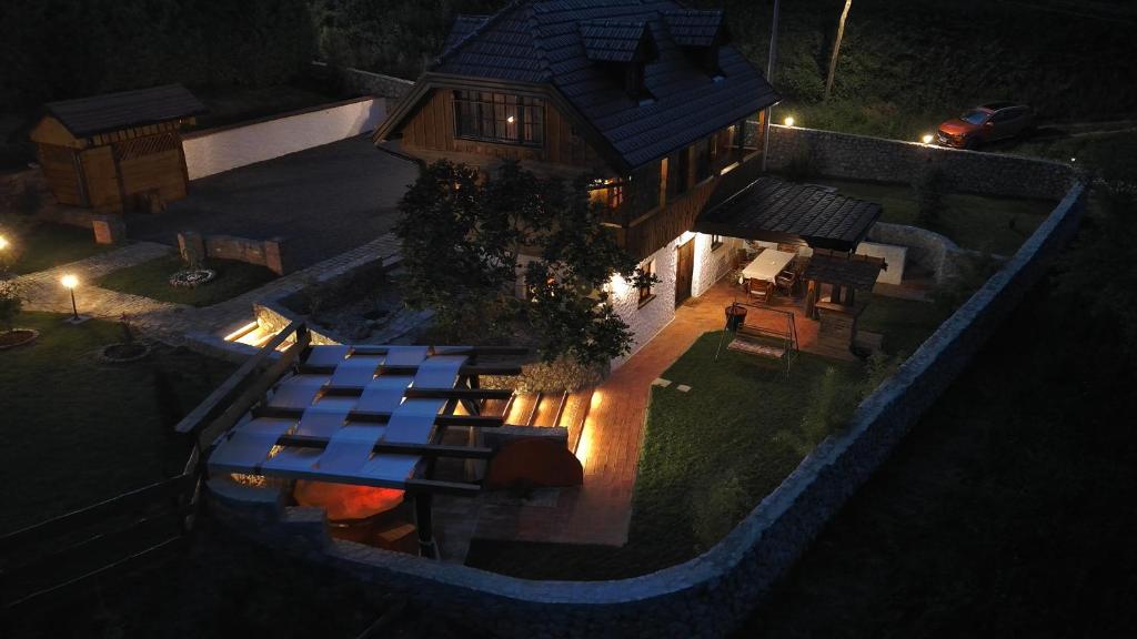 an overhead view of a house with a swimming pool at night at Villa Karolina in Veliki Erjavec