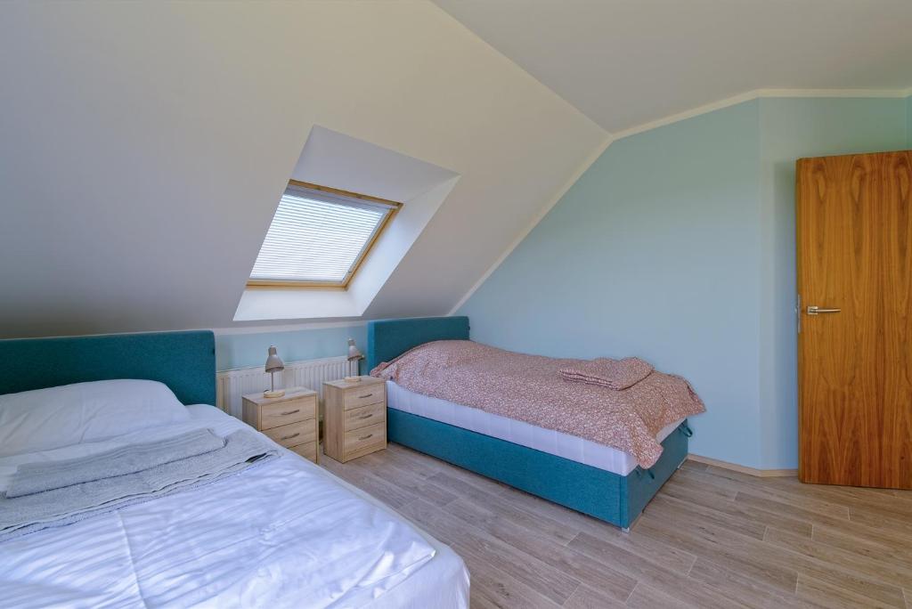 Una cama o camas en una habitación de Villa Tuchoměřice