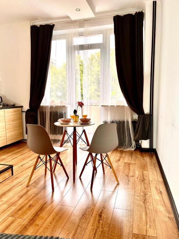 a dining room with a table and two chairs at Final 1room Condo WarszawaCenter in Warsaw