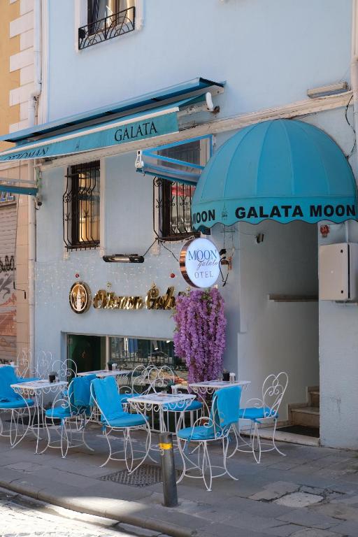 a group of tables and chairs in front of a building at Galata Moon Hotel in Istanbul
