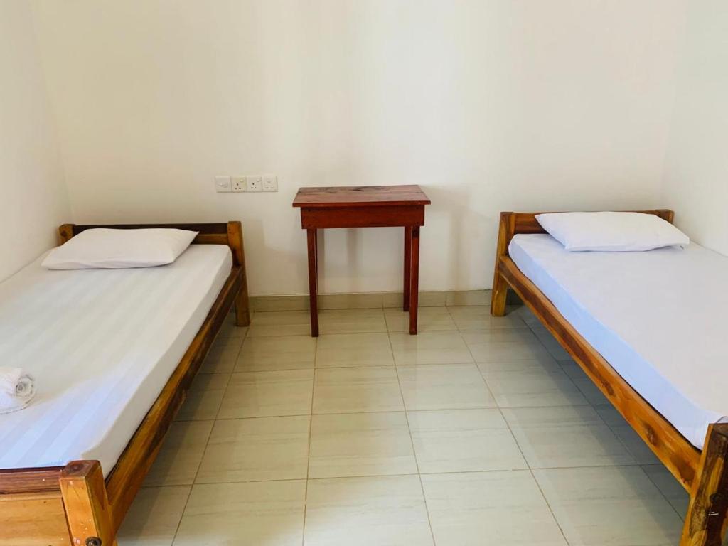 Postel nebo postele na pokoji v ubytování ZIMBAY Guest House