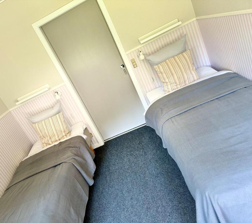 Postel nebo postele na pokoji v ubytování Hotel Skovpavillonen