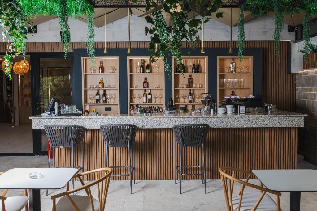 a bar in a restaurant with chairs and tables at Regent Resort Budva in Budva
