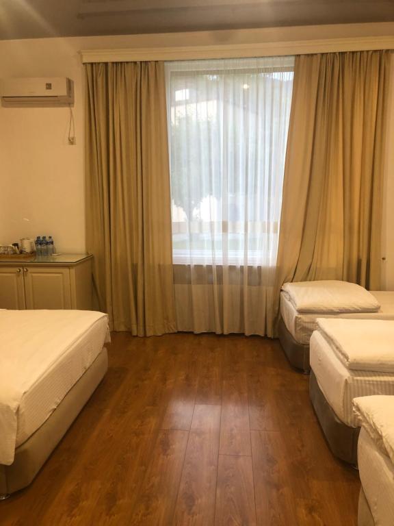 Postel nebo postele na pokoji v ubytování Wald Hotel Lagodekhi
