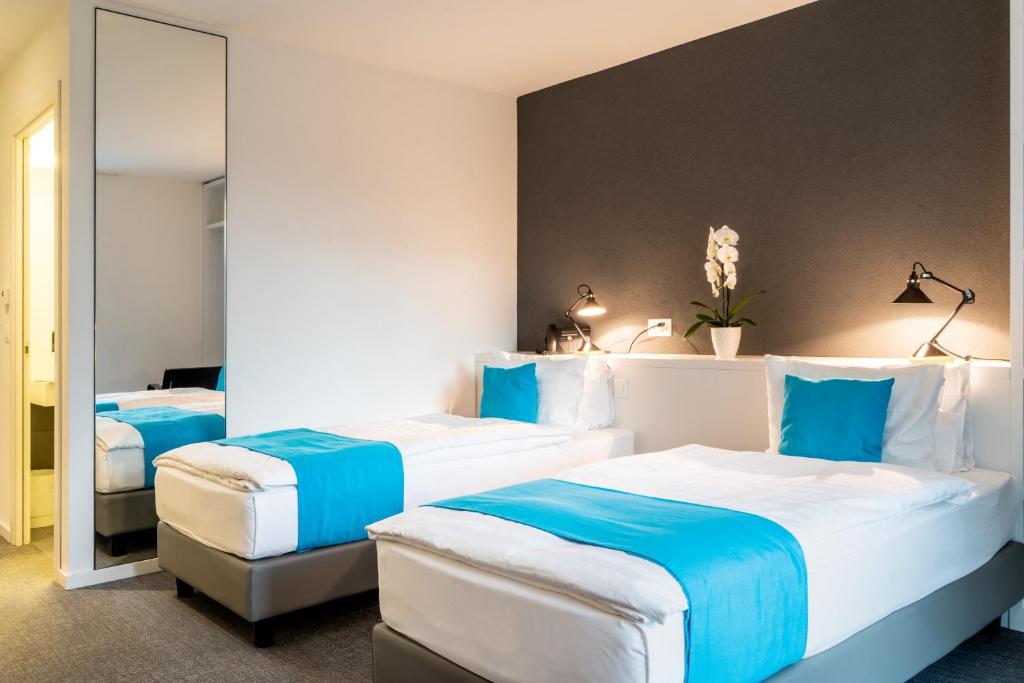 Voodi või voodid majutusasutuse Hôtel de la Source toas