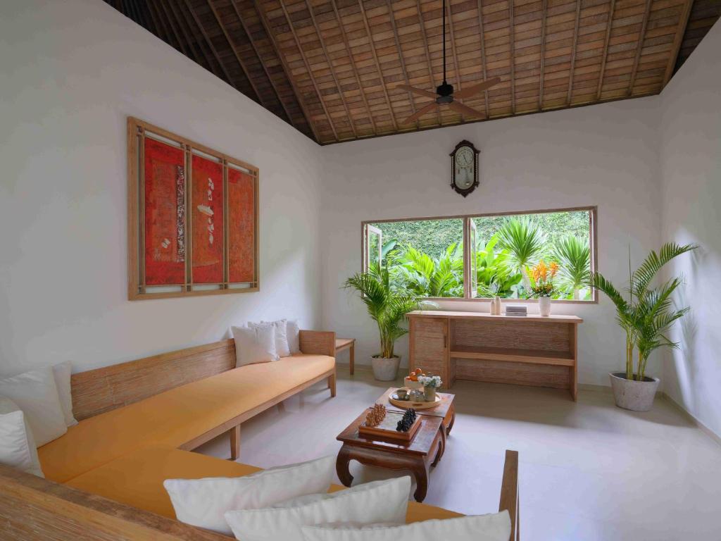 a living room with a couch and a table at Blu-Zea Resort by Double-Six in Seminyak