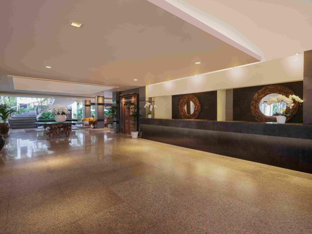 a large lobby with a reception desk in a building at Blu-Zea Resort by Double-Six in Seminyak
