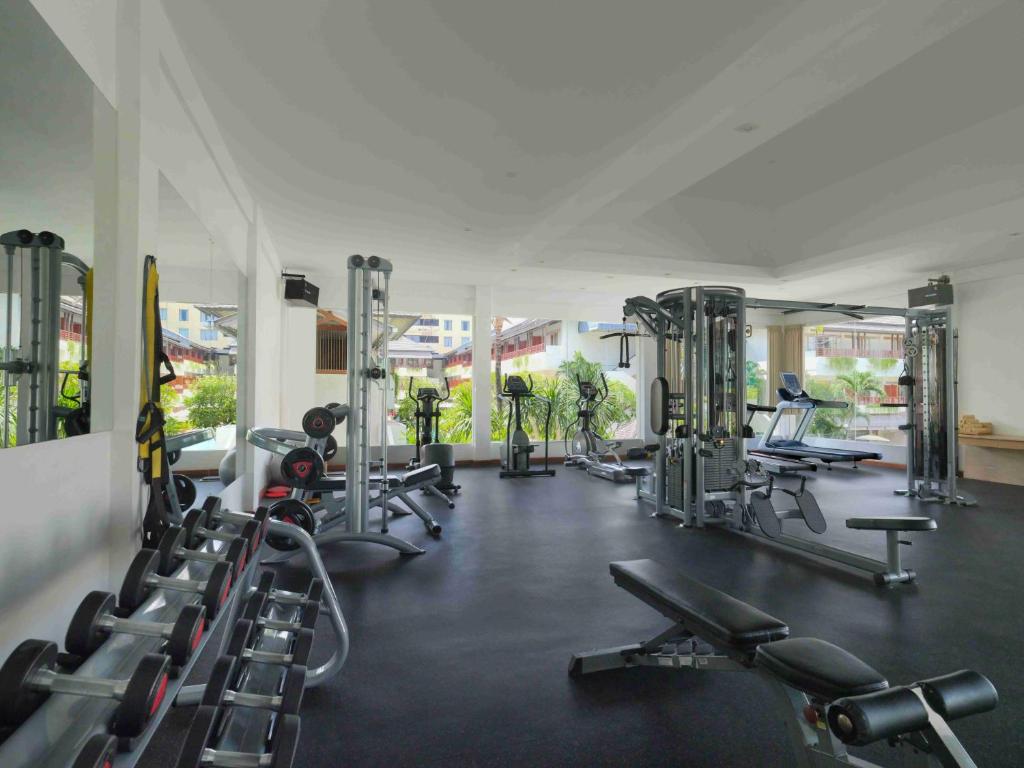 a gym with a lot of treadmills and machines at Blu-Zea Resort by Double-Six in Seminyak