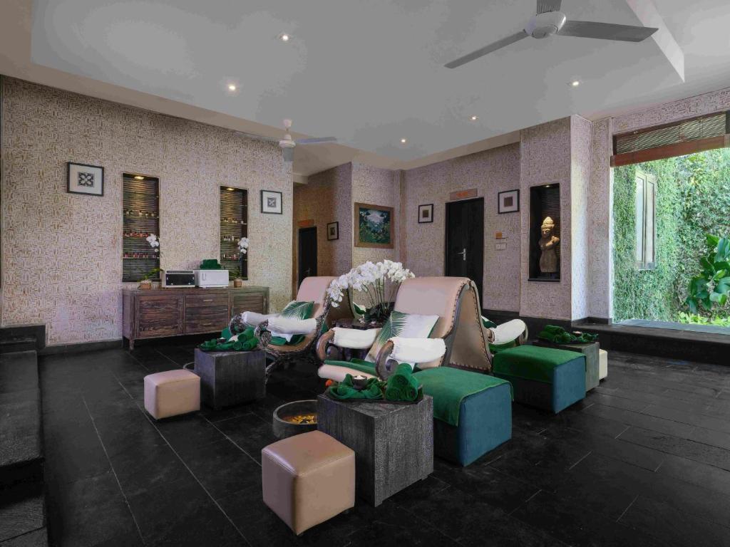 a living room with couches and chairs in a room at Blu-Zea Resort by Double-Six in Seminyak