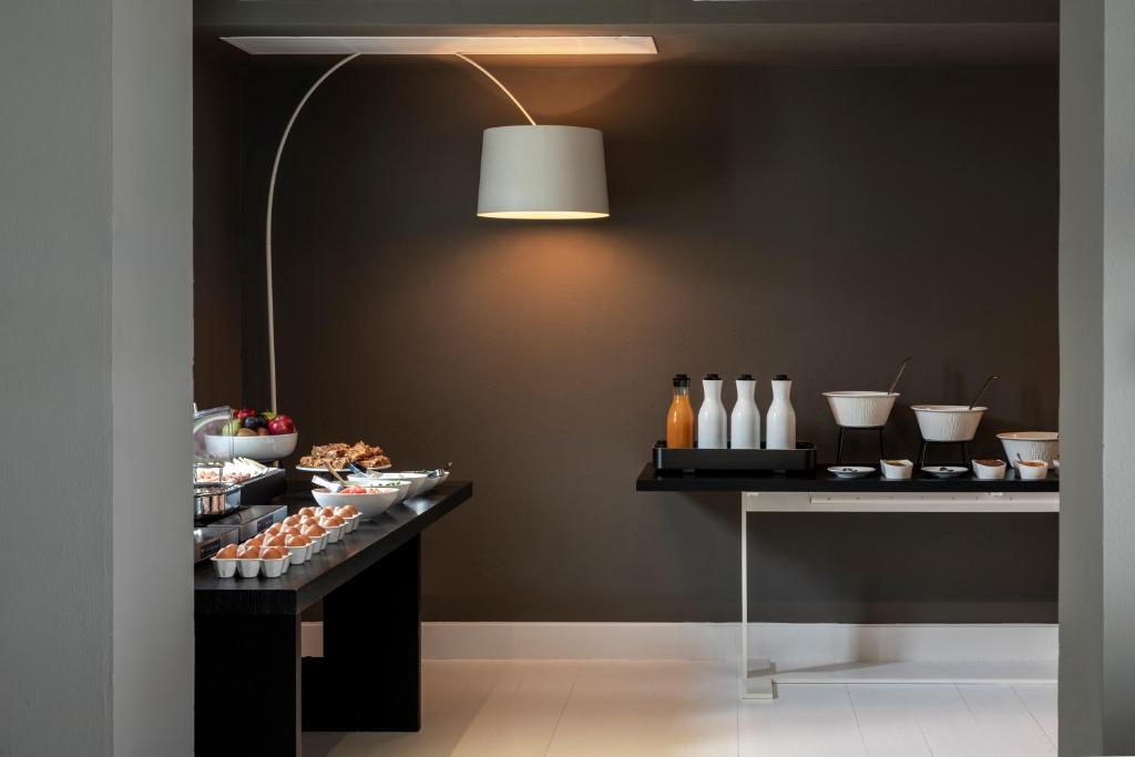 a room with a table with food and a lamp at ANEMI Folegandros in Karavostasi