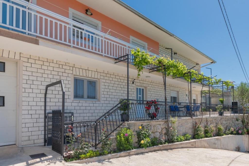 a building with a balcony and some plants at Villa GRACO in Imotski
