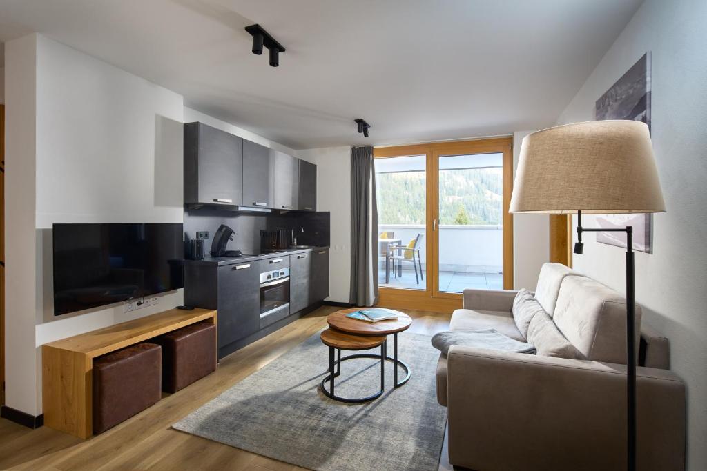 a living room with a couch and a table at Belvedere - Alpin-Resort Montafon Haus 3 by Pferd auf Wolke in Gargellen