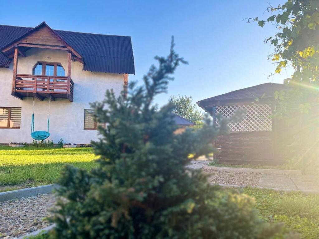 a house with a tree in front of it at Nice House in Slavske