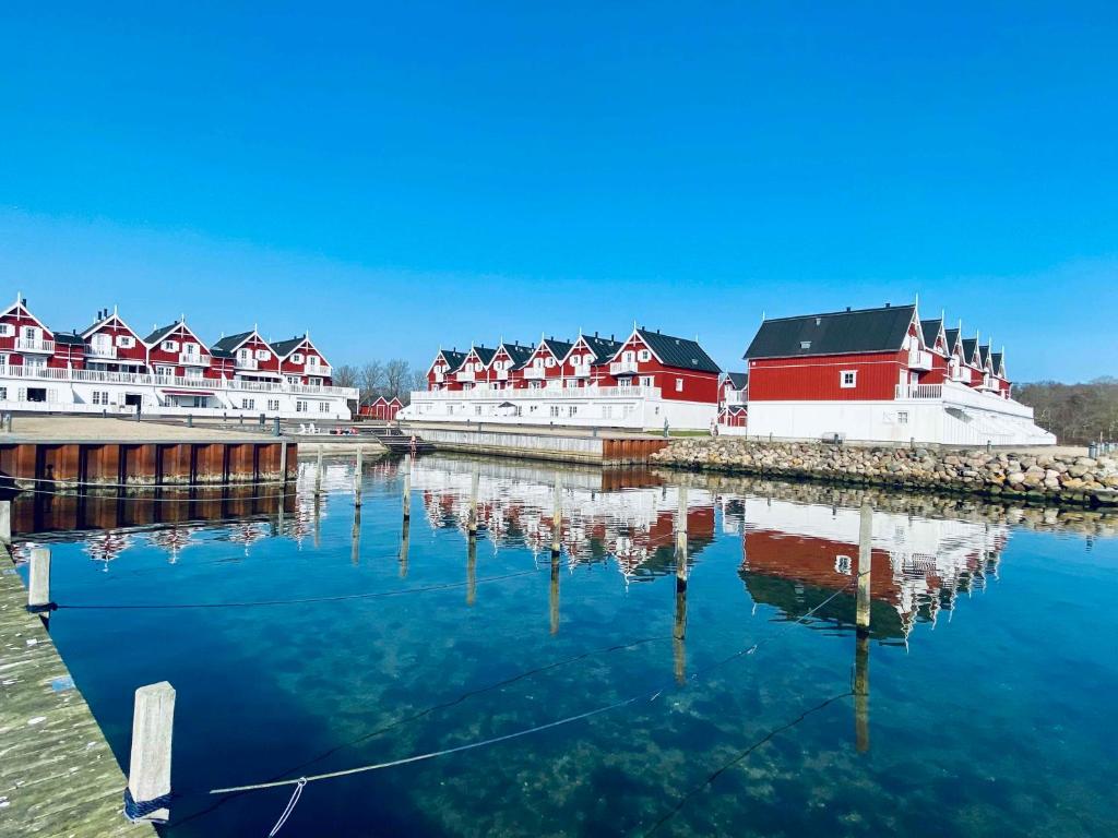 a group of red and white buildings on the water at Luxury Holiday Home With Sea View in Gråsten