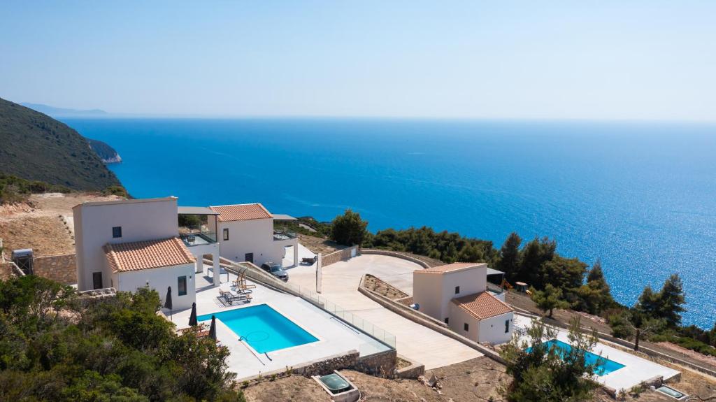 an image of a villa with a swimming pool and the ocean at Lefkadian Gem Villas in Áyios Nikólaos Nirás
