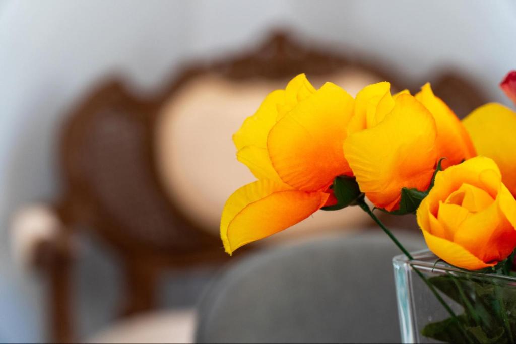 a vase filled with yellow flowers on a table at Villa Angelique in Sinarádes