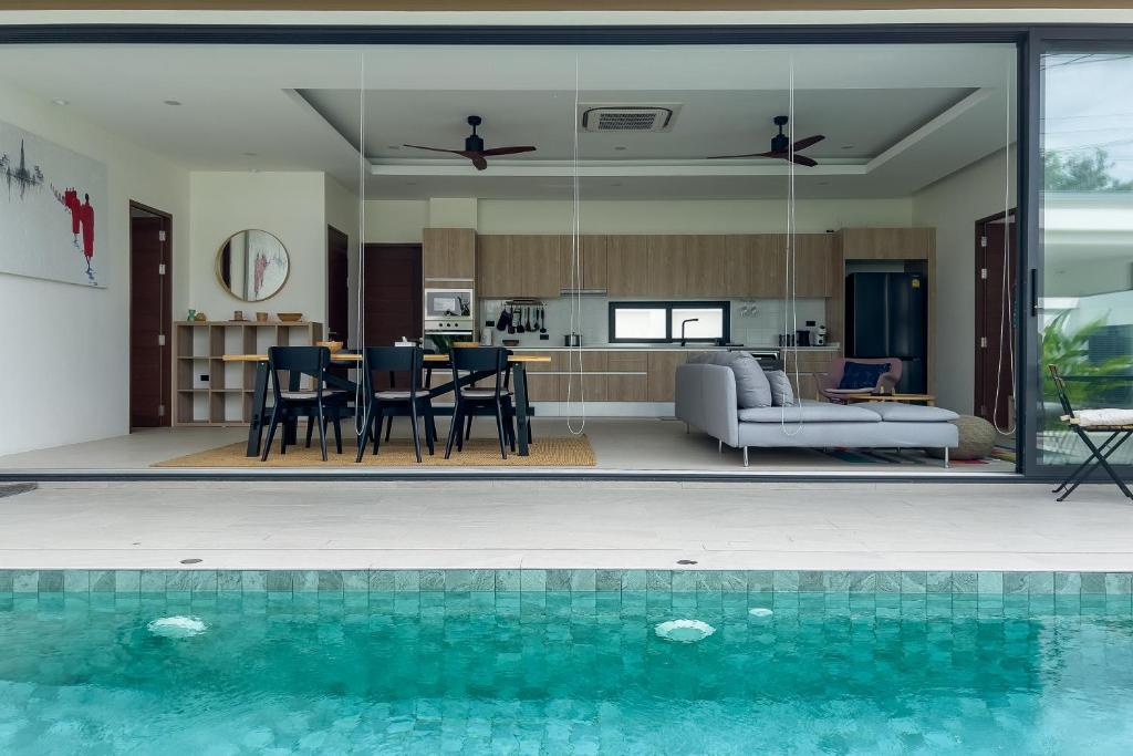 a house with a swimming pool and a living room at Stephanie villa by fisherman Village in Nathon Bay