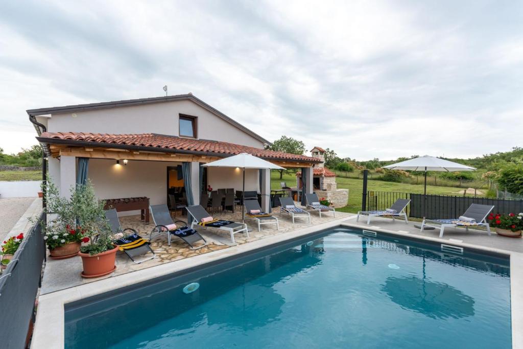 a villa with a swimming pool and a house at Modern villa Bibali Istra with pool in Buje in Bibali
