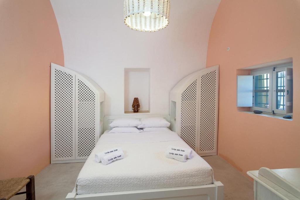 Postel nebo postele na pokoji v ubytování Cortile delle Stelle